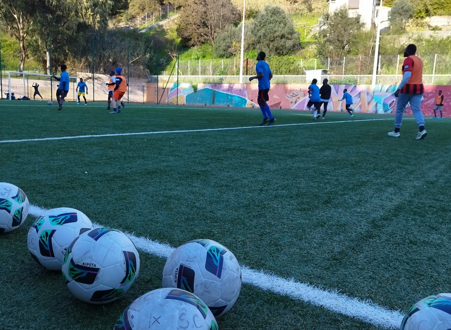 Ballons de football sur terrain d'entraînement